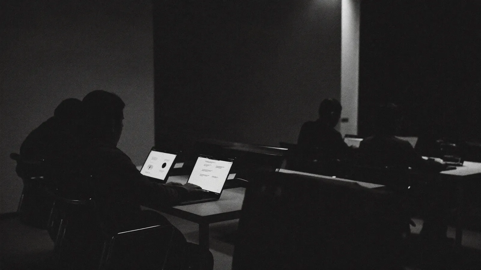 IT team working on MacBooks during an implementation workshop